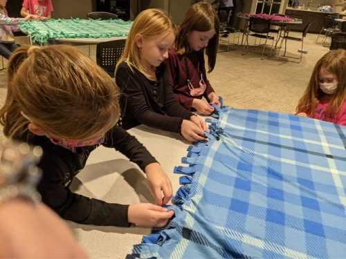 Girl scout troop donation making blankets